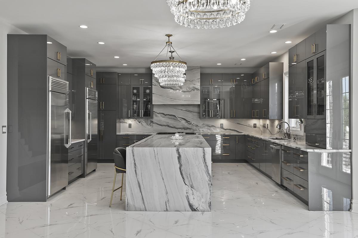Luxury gray kitchen with crystal chandeliers and marble island